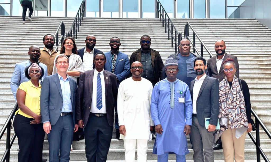 Group photo of the participants of the first annual consortium meeting 2023 of STAIRS standing on the stairs of the main entrance outside.