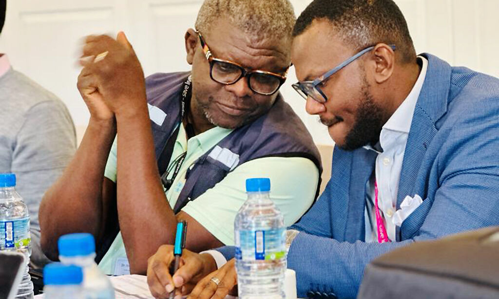 Close shot of two people discussing things in a private conversation at a table.